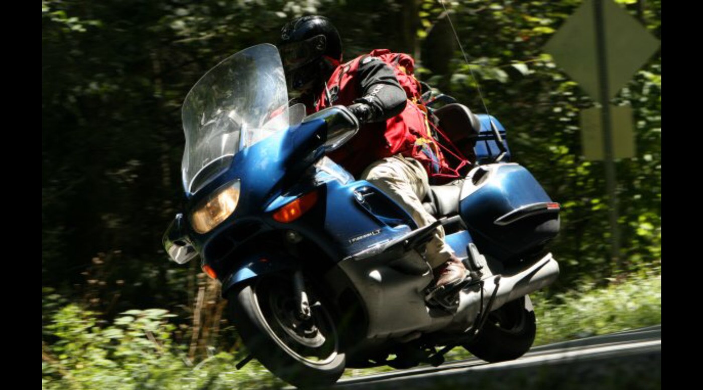 Grace leaned through a wooded curve, all luggage aboard